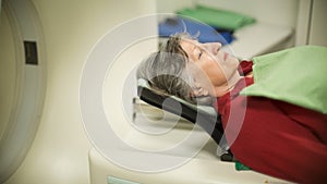 Old woman patient at computerized axial tomography (CAT) scan.Examining cancer patient with CT.Tumor detection