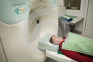 Old woman patient at computerized axial tomography (CAT) scan.Examining cancer patient with CT.Tumor detection