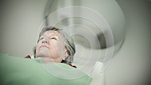 Old woman patient at computerized axial tomography (CAT) scan.Examining cancer patient with CT.Tumor detection photo