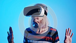 Old woman pensioner experiencing Virtual Reality