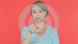 Old Woman Pointing at the Camera on Red Background