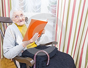 Old woman reading book photo