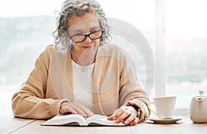 Old woman reading book, story or bible to relax in hobby or retirement for peace or learning religion. Elderly studying