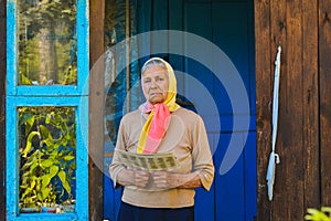 The old woman is reading the newspaper.