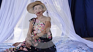 Old woman relaxing in a cottage