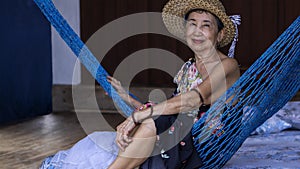 Old woman relaxing on a hammock
