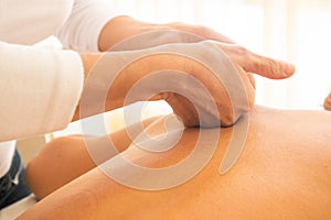 Old Woman relaxing on massage table receiving massage