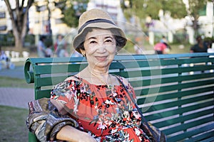 Old woman relaxing at the park