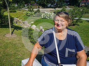 Old woman resting in the city Park