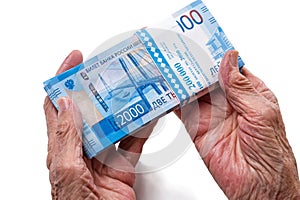 Old woman with Russian paper money 2000 rubles