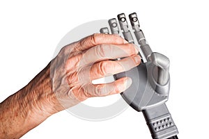 Old woman`s hand holding an artificial hand