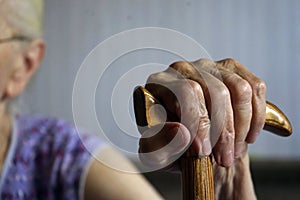 Old woman`s hand holding walking stick