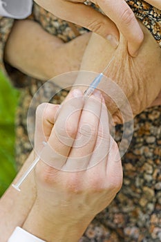 Old woman's hypodermic injection photo