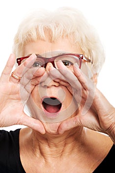 An old woman is shouting/ calling.