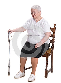 Old woman sitting with a cane