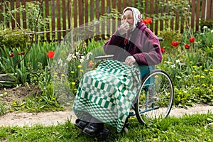 Old woman sitting in a wheelchair looking sad and worried. depression, healthcare and caring for the elderly