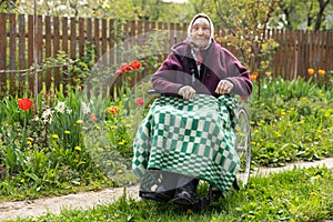 Old woman sitting in a wheelchair looking sad and worried. depression, healthcare and caring for the elderly