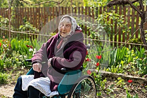 Old woman sitting in a wheelchair looking sad and worried. depression, healthcare and caring for the elderly