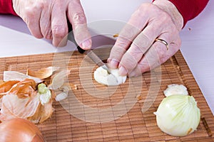 Old Woman is slicing onions