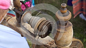 Old woman spinning wool