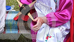 Old woman spinning wool