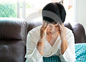 Old woman suffering from headache, stress, migraine, health problem concept photo