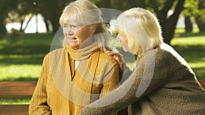 Old woman supporting friend in trouble, coping together with loss, compassion