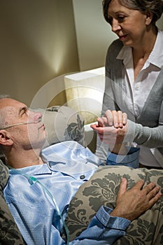 Old woman taking care of sick husband