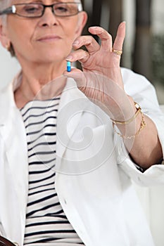 Old woman taking medication