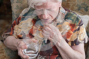 Old woman taking medication