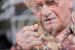 Old woman taking medication