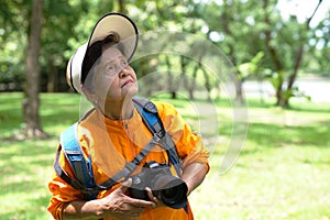 The old woman taking photo on camera. Grandmother wants to capture the moment.