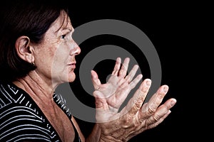 Old woman talking and gesturing with her hands