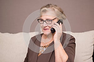 Old woman talking on the phone