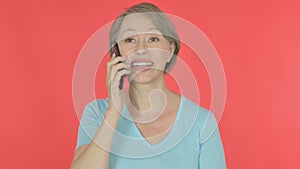 Old Woman Talking on Phone on Red Background