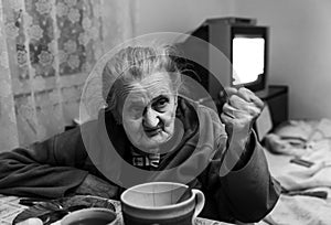 Old woman threatening by fist