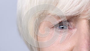 Old woman tightly closing her eyes, depression, problems with health, cataracts