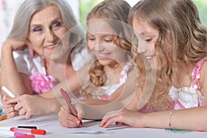 Old woman with tweenie girls drawing