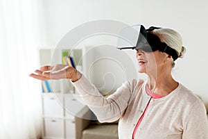 Old woman in virtual reality headset or 3d glasses