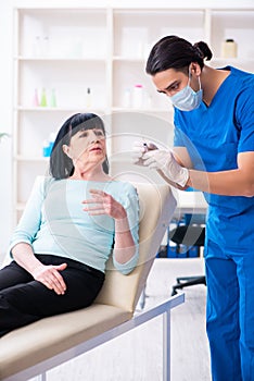 Old woman visiting male doctor for plastic surgery