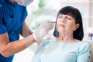 Old woman visiting male doctor for plastic surgery