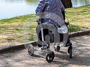 Old woman with walking aid in the park