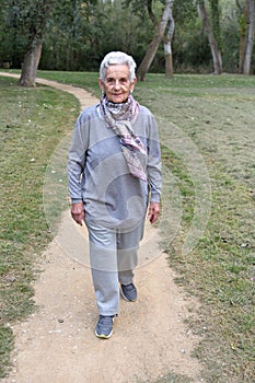 Old woman walking in a park