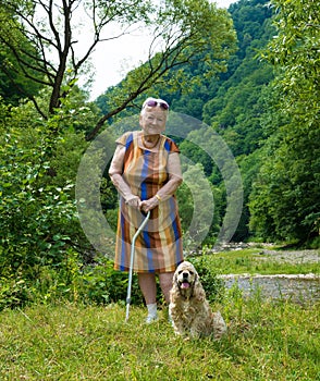 Old woman walking in summer park