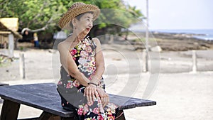 Old woman watching the sea