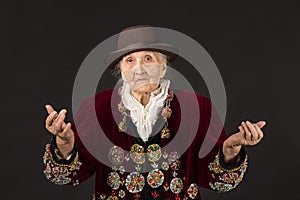 Old woman wearing a vermilion velvet jacket