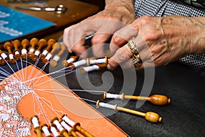 Old woman working on bobbin lace photo