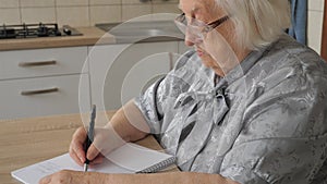 Old woman is writing letter or the last will