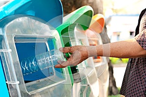 Old women hand throwing away the garbage to the bin/trash, sorting waste/garbage before drop to the bin