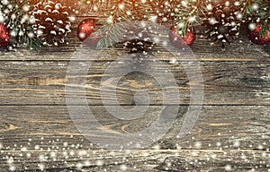 Old wood background with fir branches adorned with baubles and cones. Space for text. Christmas card. Top view. Xmas. Effect of